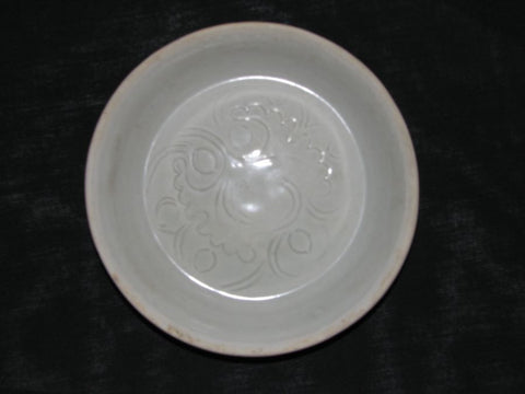 A Qingbai saucer with carved floral decoration.