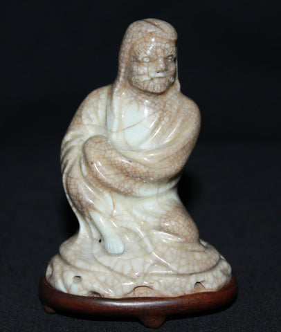 An early Qing Dynasty porcelain figure of a lohan.