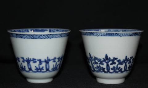 A pair of blue and white wine cups.