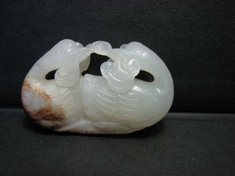 A white and russet jade carving of Mandarin ducks.